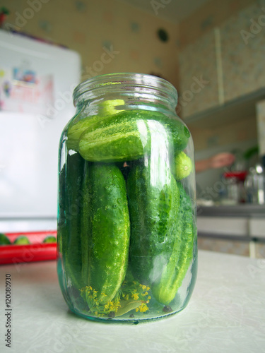 Glass jar full of cucumder for home preservation photo