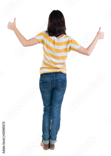 Back view of woman thumbs up. Rear view people collection. backside view of person. Isolated over white background. slender brunette in a jeans shows the symbol of success or hitchhiking