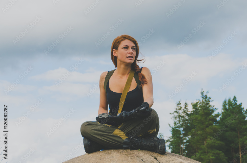 girl soldier with red hair on a sky background.