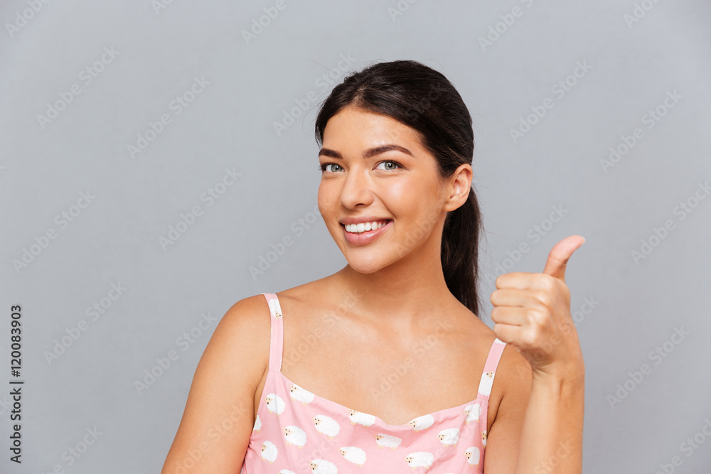 Smiling attractive young woman pointing finger at camera Smiling attractive young woman pointing finger at camera