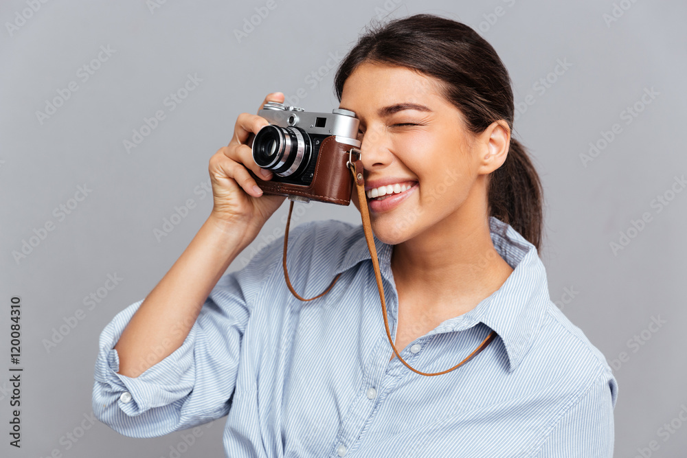 Portrait of a cheerful woman making photo with camera Portrait of a cheerful woman making photo with camera