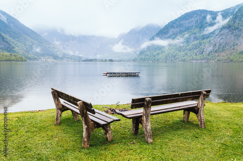 Benches in the lake a foggy day. Hallstatt, Austria. photo