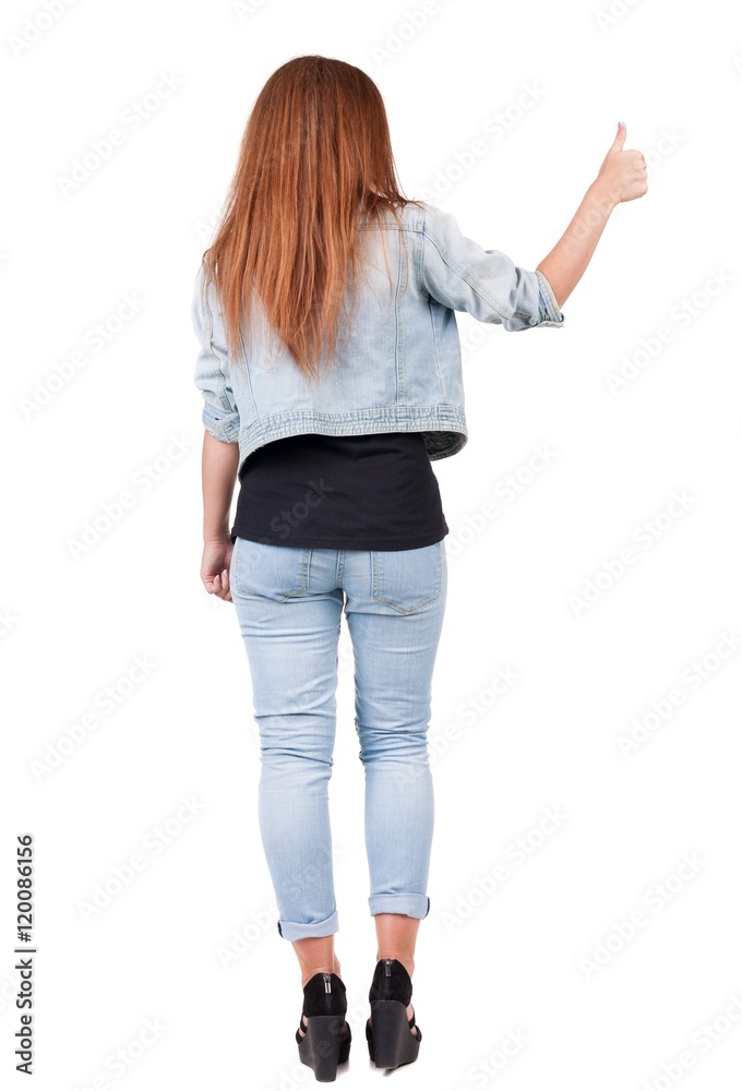 Back view of woman thumbs up. Rear view people collection. backside view of person. Isolated over white background. slender redhead in a jeans shows the symbol of success or hitchhiking Back view of woman thumbs up. Rear view people collection. backside view of person. Isolated over white background. slender redhead in a jeans shows the symbol of success or hitchhiking