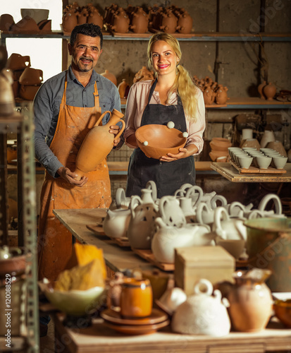 Two artisans in ceramics workshop.