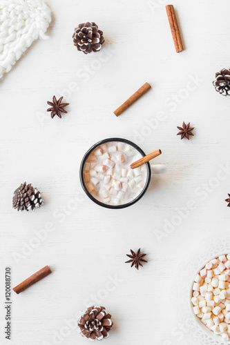 Fototapeta Naklejka Na Ścianę i Meble -  Christmas. Winter. Hot chocolate, cinnamon sticks, anise star, marshmallow, knitted blanket and cones. Christmas composition. Flat lay, top view
