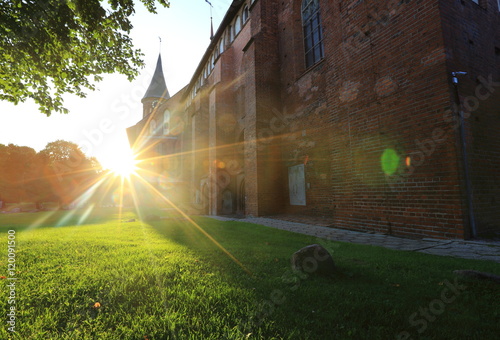 Konigsberg Cathedral on the island Kant (Knaypkhof) in the rays of the setting sun photo