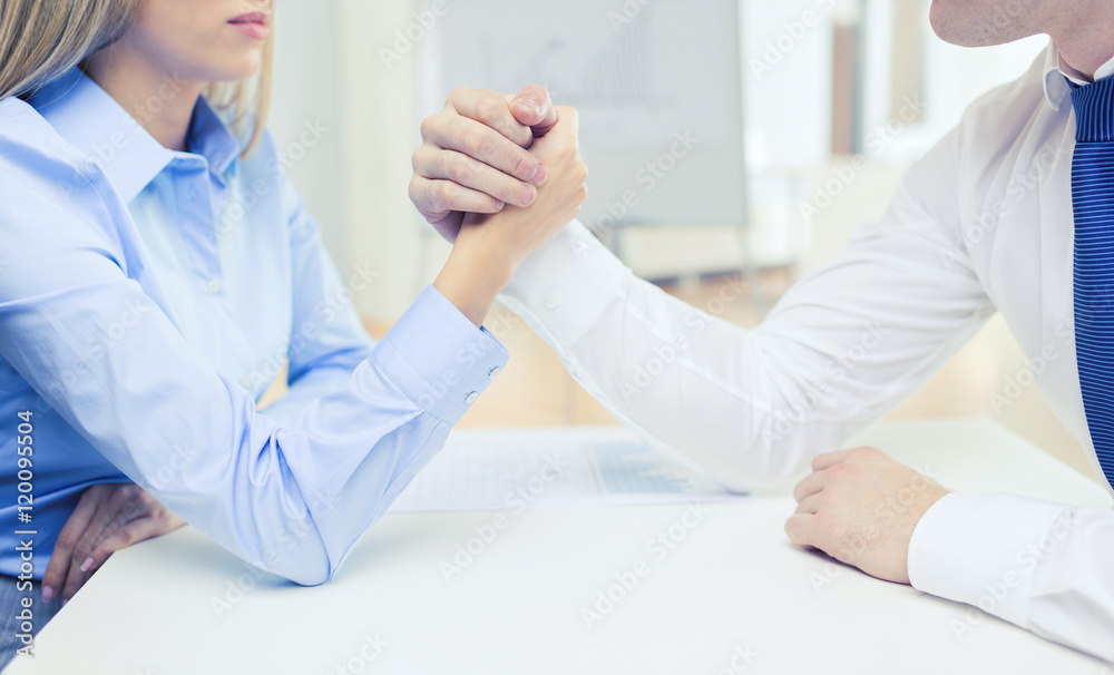 Fototapeta premium businesswoman and businessman arm wrestling