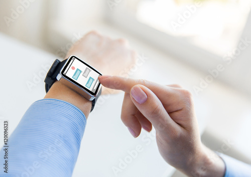 close up of hands with messenger on smart watch