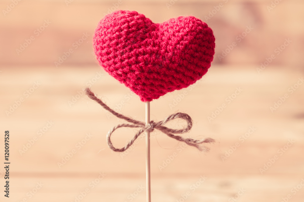 love heart yarn on wood stick with wood background, sweet love symbol.