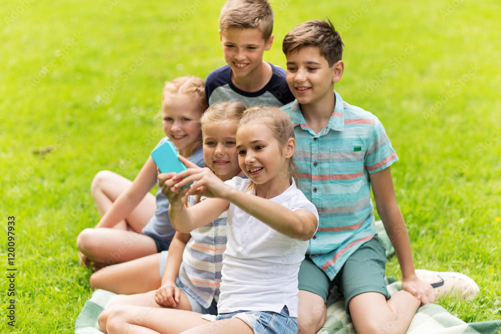 happy kids or friends taking selfie in summer park happy kids or friends taking selfie in summer park