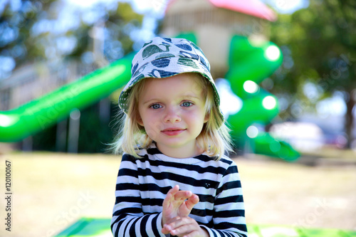 Photo of Pretty little girl in a striped shirt and hat