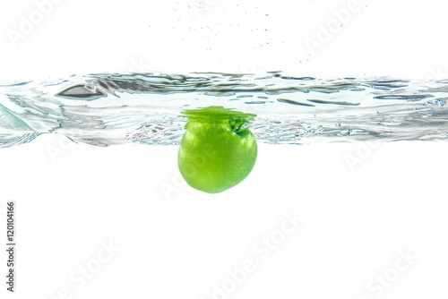 Water splash. Green apple under water. Air bubble and transparen