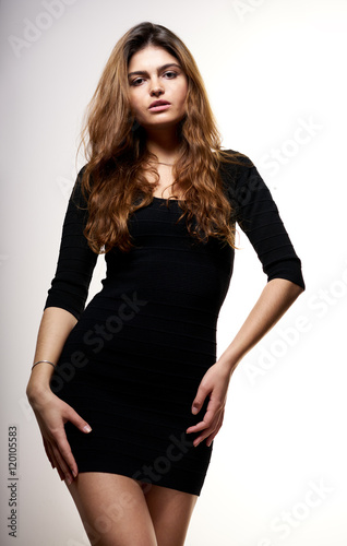 Portrait of a young pretty woman in black dress