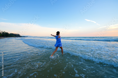 Asian girl running toward water