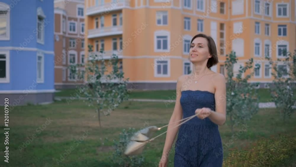 Beautiful young woman in a blue dress, goes on tratuary fun to meet her husband. Beautiful young woman in a blue dress, goes on tratuary fun to meet her husband.