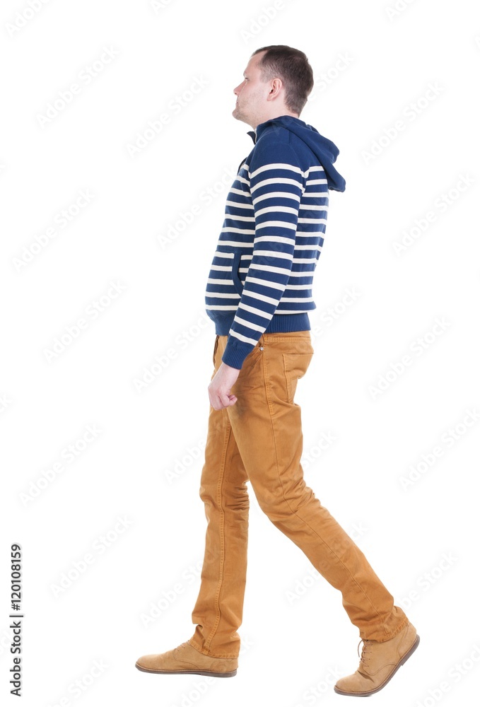 Fototapeta premium Back view of walking handsome man in jeans and striped sweater. young guy going . Rear view people collection. backside view of person. Isolated over white background.