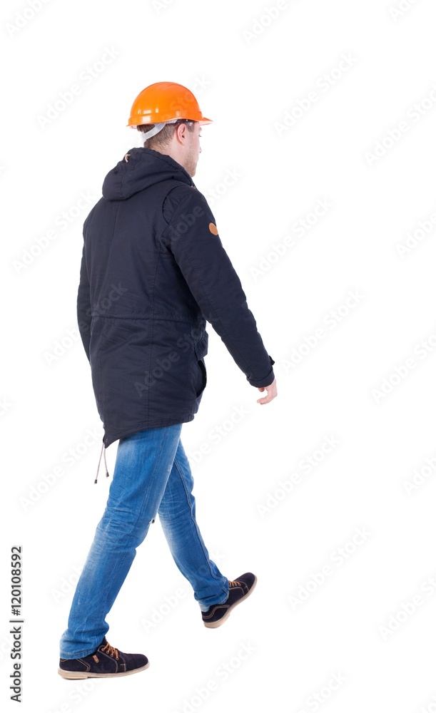 Back view of goingWorker in a helmet. walking young engineer. Rear view people collection. backside view of person. Isolated over white background. Back view of goingWorker in a helmet. walking young engineer. Rear view people collection. backside view of person. Isolated over white background.