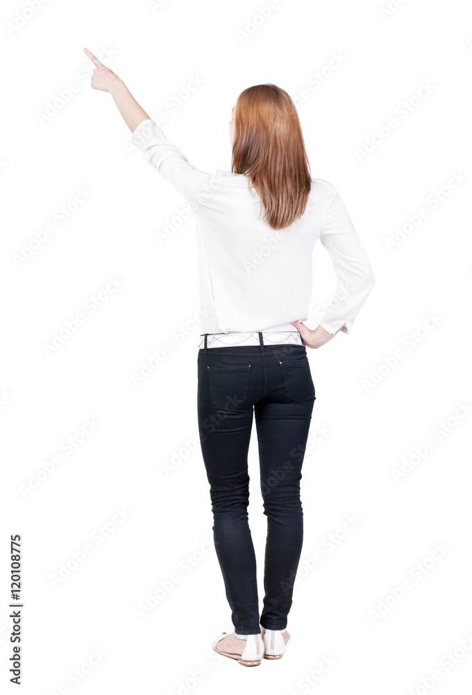 Back view of young brunette woman pointing at wall. beautiful girl. Rear view people collection. backside view of person. Isolated over white background. Back view of young brunette woman pointing at wall. beautiful girl. Rear view people collection. backside view of person. Isolated over white background.