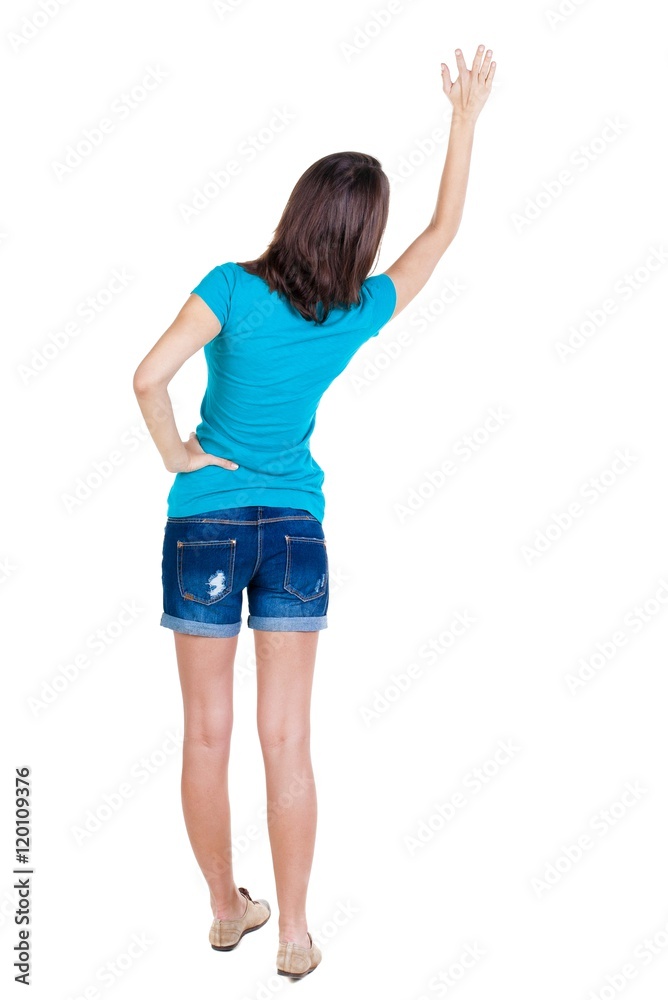 Back view of beautiful woman welcomes. Young teenager girl in shorts hand waving from. Rear view people collection. backside view of person. Isolated over white background. Back view of beautiful woman welcomes. Young teenager girl in shorts hand waving from. Rear view people collection. backside view of person. Isolated over white background.