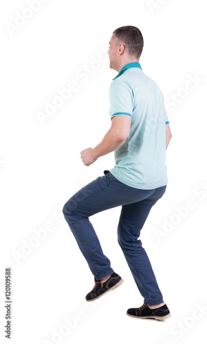 Back view of running man in blue polo. Walking guy in motion. Rear view people collection. Backside view of person. Isolated over white background. © ghoststone
