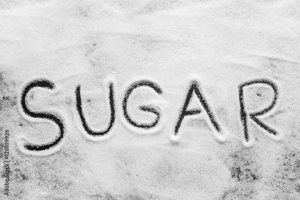 White sugar. White sugar with sugar word on dark wooden backgrou White sugar. White sugar with sugar word on dark wooden backgrou