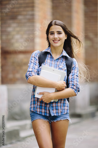 Young beauty girl with handbag goind to study to University