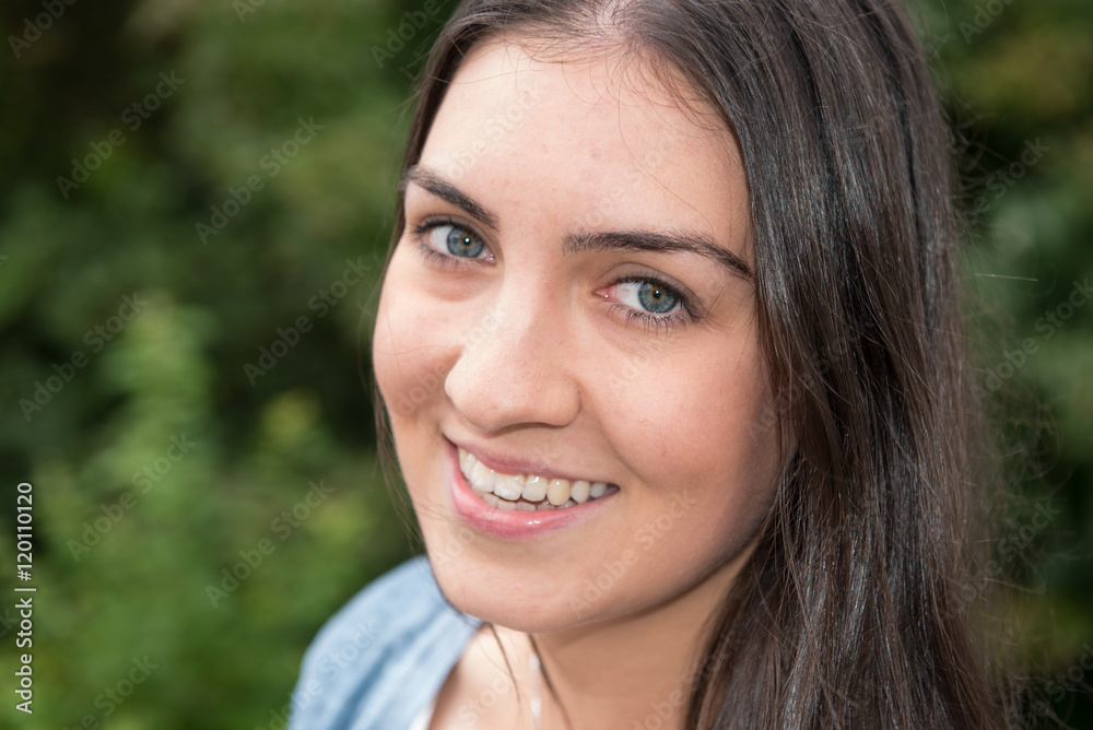 Portrait of a young beautiful woman standing outside