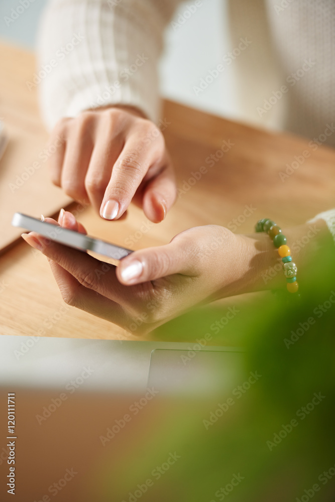 Close-up image of woman checking her smartphone