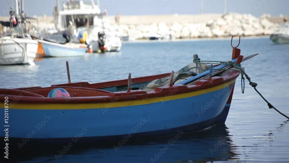 A lone boat in a haven, with a volley ball, slowly moving.
A lone boat in a haven, with a volley ball, slowly moving.