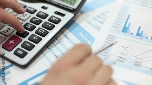 businessman analyses financial data calculator