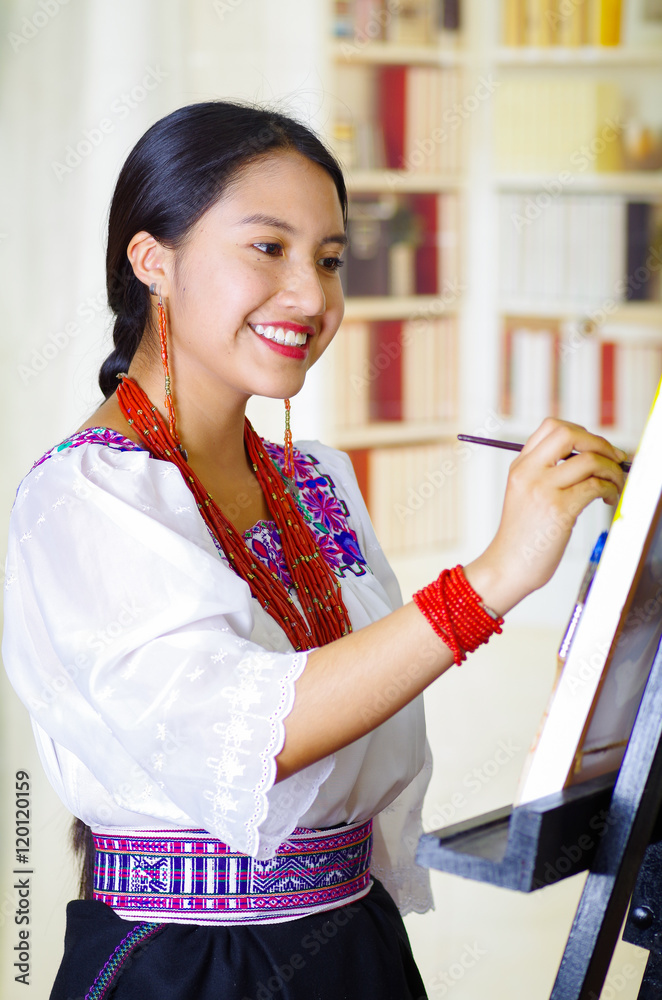Φωτογραφία Young brunette woman wearing traditional andean clothing painting on canvas insi