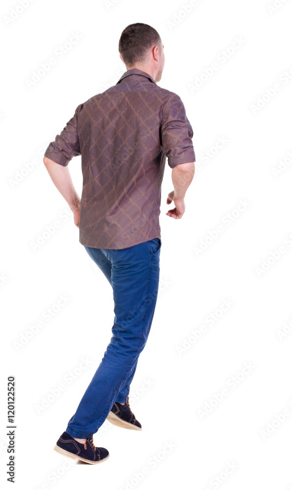 Back view of running man in brown shirt. Walking guy in motion. Rear view people collection. Backside view of person. Isolated over white background.