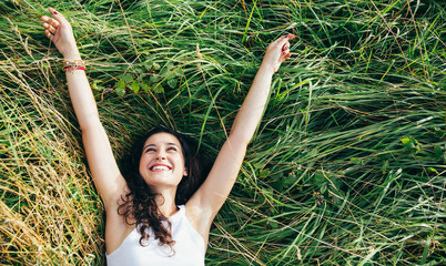 Happy girl in a bed of grass
