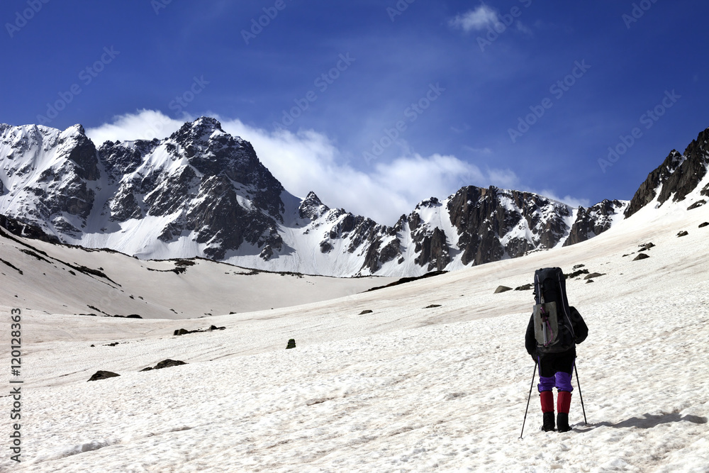Hiker on snow plateau at spring mountain.