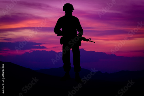 Silhouette of combat soldier circa Vietnam War Era. Set against nice purple sunset background.