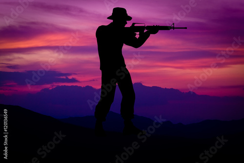 Silhouette of combat soldier circa Vietnam War Era. Set against nice purple sunset background.