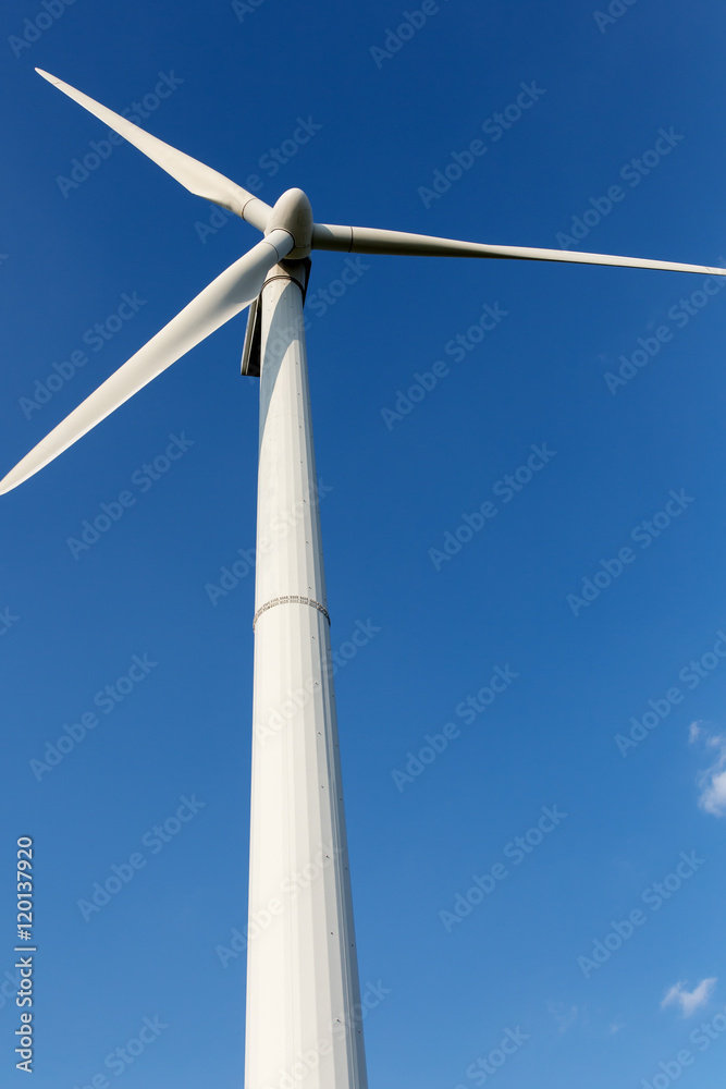 Energy windmill produce energy on blue sky at daytime Energy windmill produce energy on blue sky at daytime