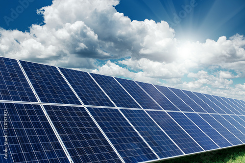 Solar panels generate power energy on blue sky at daytime