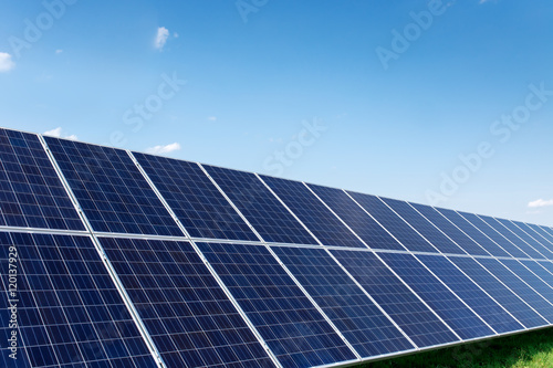 Solar panels generate power energy on blue sky at daytime