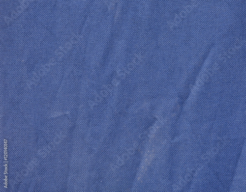 Navy blue fabric with pleats. Fabric background or wallpaper.