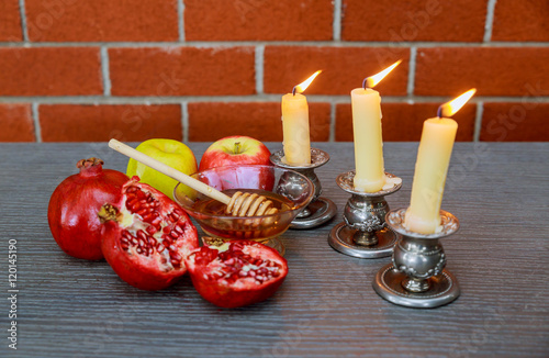 Rosh hashanah jewesh holiday concept: honey, apple pomegranate photo