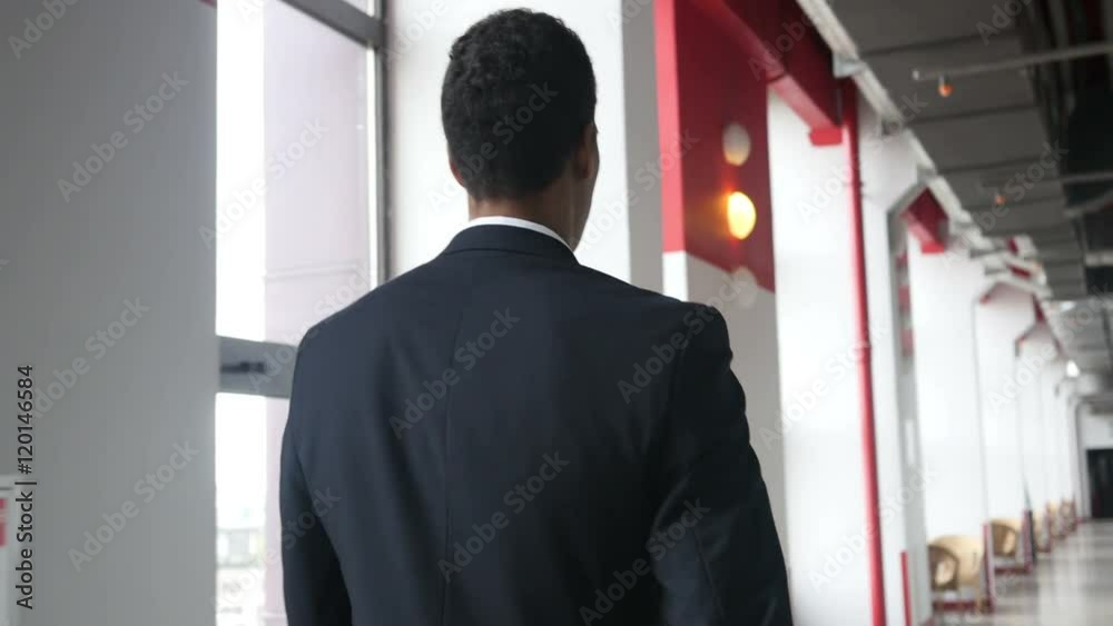 Walking Businessman in Corridor of Office, Back View Walking Businessman in Corridor of Office, Back View