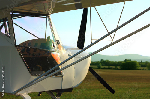 Ultralight aircraft close up in sunset with reflection