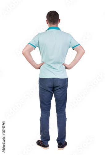 Back view of handsome man in polo looking up. Standing young guy in jeans. Rear view people collection. backside view of person. Isolated over white background.
