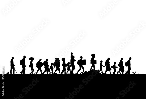 Silhouette of a group of refugees walking through a field