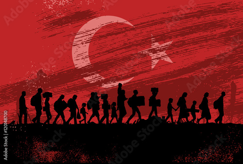 Silhouette of refugees walking against flag of Turkey