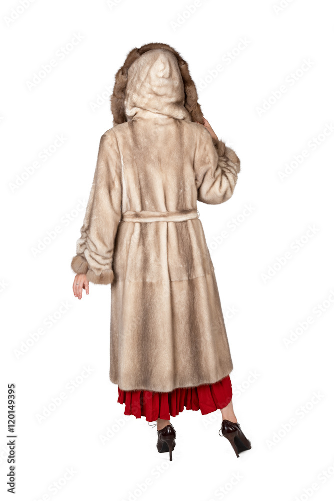 Young woman wearing fur coat on white background. No face