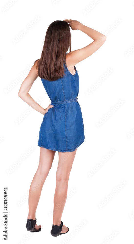 back view of woman shielding his eyes from the sun. brunette girl in red dress and kitten heels watching. Rear view people collection. backside view of person. Isolated over white background. back view of woman shielding his eyes from the sun. brunette girl in red dress and kitten heels watching. Rear view people collection. backside view of person. Isolated over white background.
