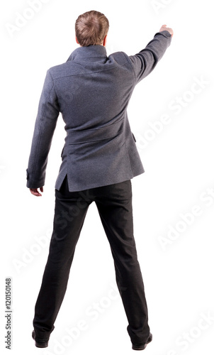 Back view of pointing business man. gesticulating young guy in gray coat. Rear view people collection.  backside view of person.  Isolated over white background.