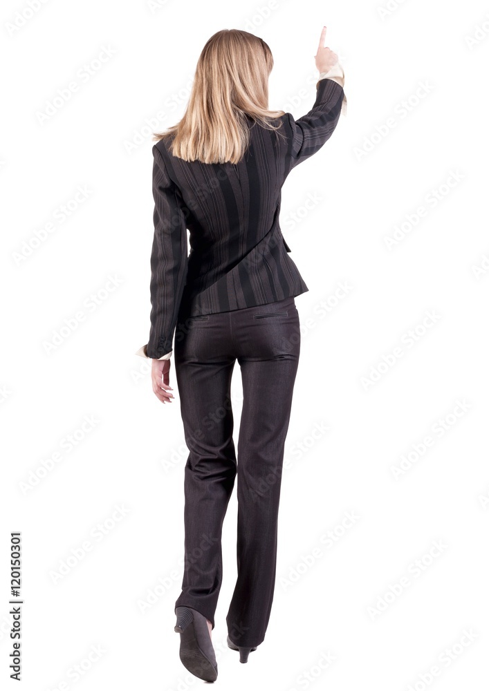 Back view of business woman walking and pointing. young businesswoman in black suit. Rear view people collection. backside view of person. Isolated over white background. Back view of business woman walking and pointing. young businesswoman in black suit. Rear view people collection. backside view of person. Isolated over white background.